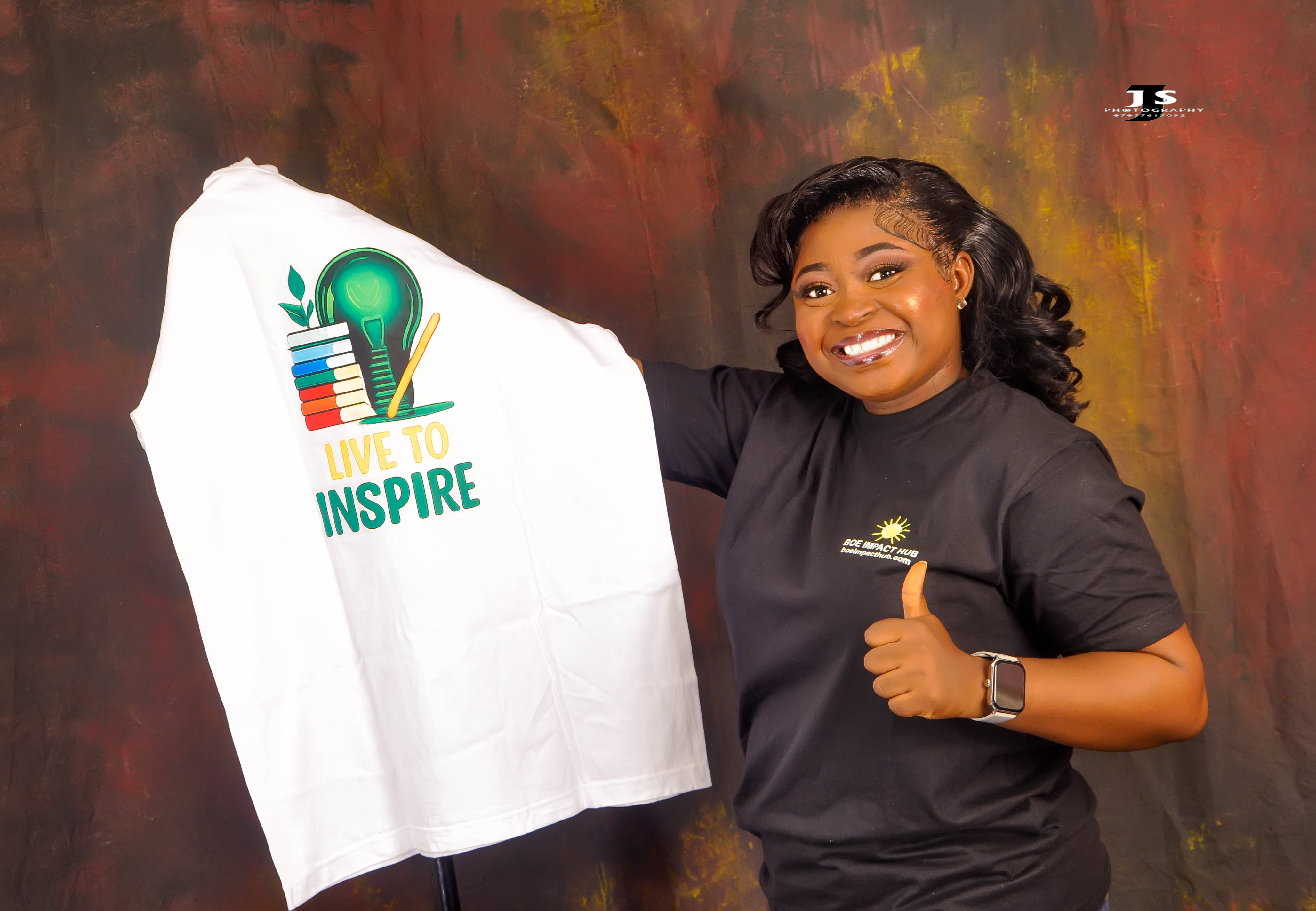 BOE holding Live to Inspire T-shirt